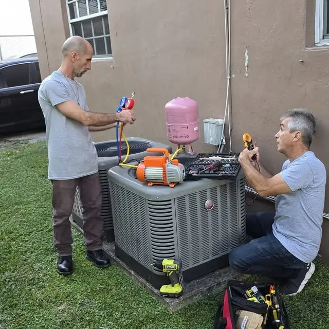 Professional refrigeration technicians at work