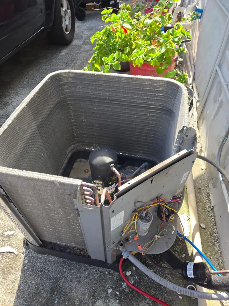 Condenser unit opened for compressor and coil service